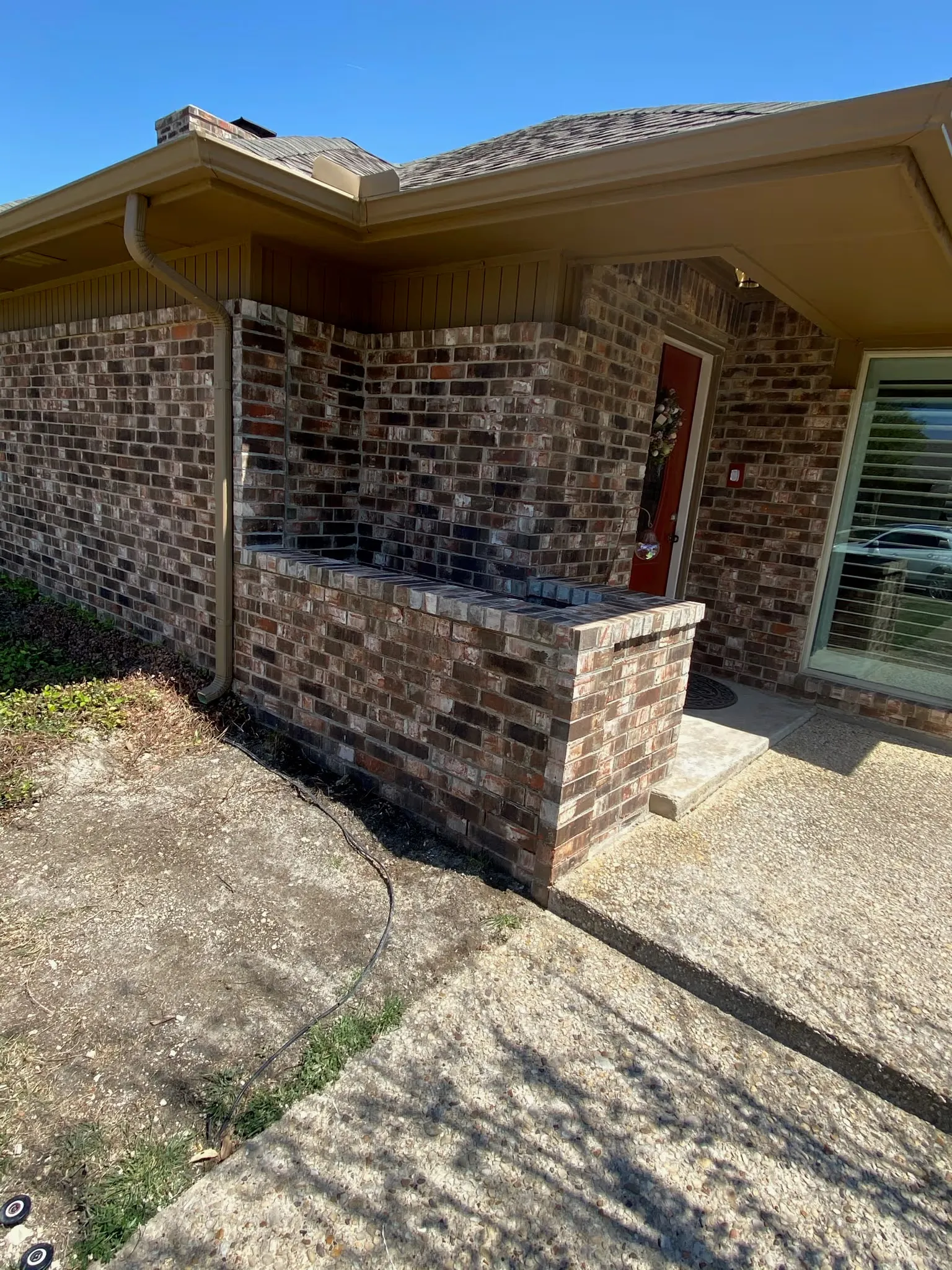 Masonry crew repairing leaning wall near White Rock Lake